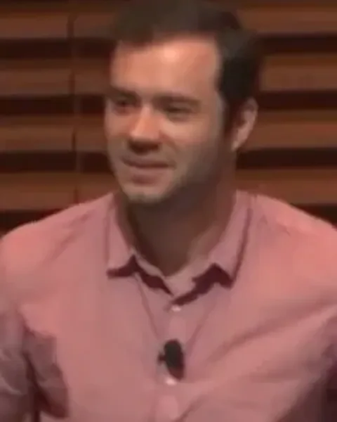 Andrej Karpathy speaking in an OpenAI video still.